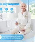 Elderly woman holding Butt Wiper Tool With Replaceable Head And 16.5 Inch Handle Locking Mushroom Head Toilet Aid seated in bathroom.