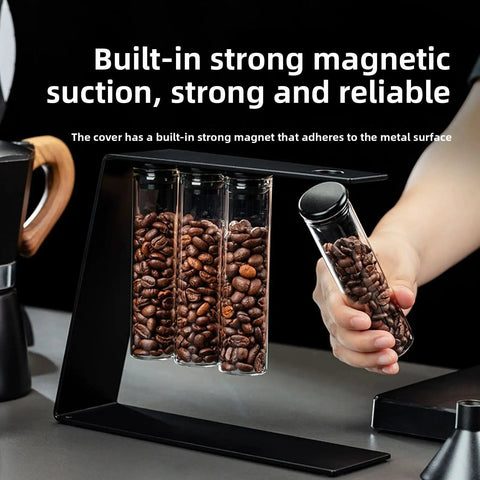 Glass Coffee Bean Storage Tubes Set Of Six With One Way Degassing Valve And Magnetic Stand And Single Dose Espresso Dosing Vials on countertop.