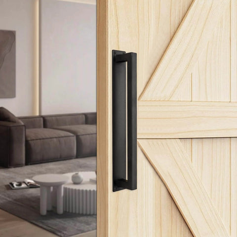 Barn Door Handle 12-Inch Heavy Duty Sliding Door Pull, Modern Farmhouse Flush Long Base Hardware For Gate, Shed, Garage, Cabinets, Matte Black Finish, Durable Iron Construction And Easy Grip installed on a wooden door.