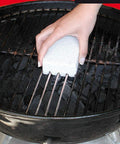 Hand using 2 Pack Grill Scrub Stone Barbecue Cleaner Scouring Brick For BBQ Grills And Griddles Fast Clean On Steel And Iron Surfaces