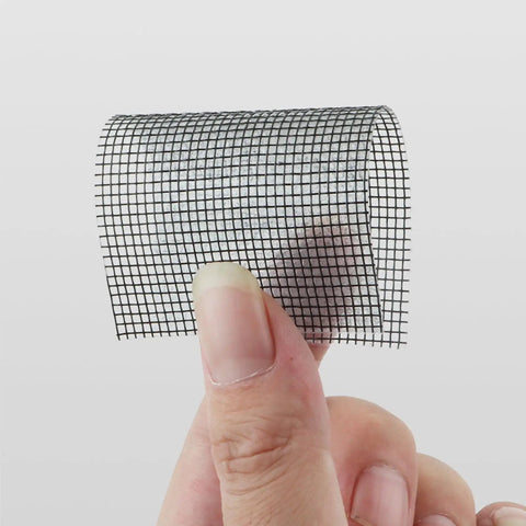 Heavy Duty Window Screen Repair Tape And Mesh Patch Kit 2 Inches By 16 Feet Long Black Adhesive Strip held in hand.