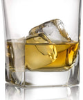 Elegant 10 oz whiskey glass from Whiskey Glass Set With Granite Chilling Stones Set Of 4 10 Oz Old Fashioned Rocks Glasses For Scotch Bourbon And Cocktails Heavy Base Barware Built For Real Talk And Chill Sips, filled with amber liquid and ice.