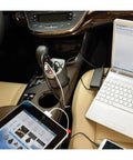 Slip Right In Road Trip Ready 200 Watt Car Power Inverter with Dual AC Outlets, charging devices in a car's cup holder.
