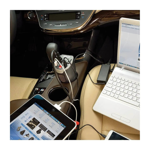 Slip Right In Road Trip Ready 200 Watt Car Power Inverter with Dual AC Outlets, charging devices in a car's cup holder.