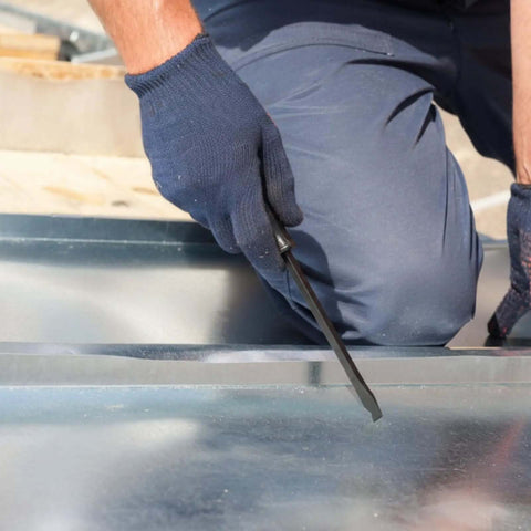 Person using 12 Inch Duct Slitter Hand Sheet Slicer For Cutting Metal Pipes And Duct Work Demolition Tool on metal sheet