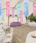 Colorful Jellyfish Paper Lanterns Set Of 6 In Pink Purple And Blue Hanging Lanterns For Mermaid Theme Under The Sea Ocean Birthday Party Decor Totally Vibrant Ocean Life Party Lighting And Backdrop Accents hanging under a canopy at an event.