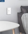 30 Pack UL Listed Toggle Light Switches With White Finish, Modern Classic Toggle Design For Any Room, Perfect For Living Rooms, Bedrooms, Kitchens And Hallways, Prevents Accidental Switching With Deliberate Pressure. White toggle switch on a bedroom wall beside a bed and side table.
