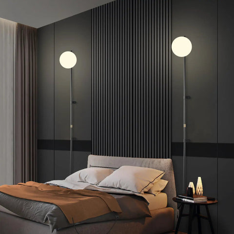 Plug In Wall Sconce With Globe Shade, Modern Indoor LED Wall Lamp in bedroom setting, showing soft warm white light from globe shade.