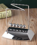 Five Pendulum Newton Cradle Desktop Ornament With 18cm Steel Balls for home office and classroom on wooden surface.