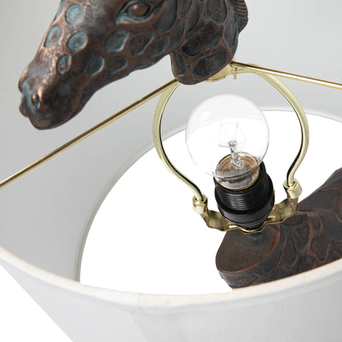Close-up of bulb and giraffe detail under shade of Resin Giraffe Table Lamp With Linen Shade And Bronze Finish Whimsical Animal Accent Light