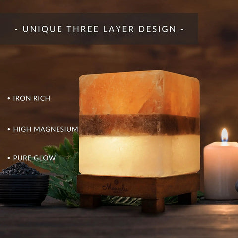 Dual Illumination Himalayan Salt Rock Lamp with Real Pink White and Grey Salt Block on neem wood stand next to candle