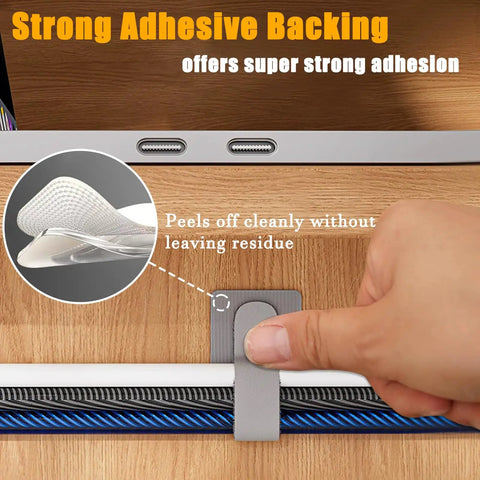 Person peeling adhesive backing of 80 Piece Set Hook And Loop Cable Straps For Desk Cable Management showing strong adhesion on wood.