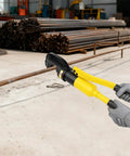 Heavy Duty 22mm Hydraulic Rebar Cutter With Sturdy Steel Toolbox For Construction Sites, cutting through steel bar at a worksite.