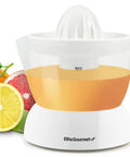 Elite Gourmet Compact Electric Citrus Juicer In White 30 Watt With 16 Oz Capacity For Fresh Orange Lemon Lime Squeezing next to fruits.