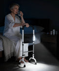 Stand Assist Rail for Elderly and Seniors, Quad Cane Mobility Aid With Four Point Support, beside bed with woman drinking water