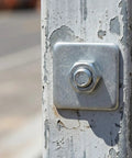 Grab You 30 Pack Of Heavy Duty Galvanized Square Washers With A Bold Silver Finish designed for major construction, shown on a pole.