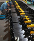 Technician assembling Hydraulic Earth Auger For Mini Excavator Backhoe Post Hole Digger Attachment for tough soil projects