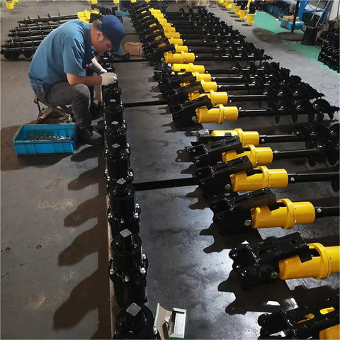 Technician assembling Hydraulic Earth Auger For Mini Excavator Backhoe Post Hole Digger Attachment for tough soil projects