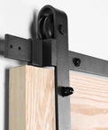 Close-up of No Fuss 6.6 Foot Sliding Barn Wood Door Hardware Kit with Premium Carbon Steel Track System showing roller and rail.
