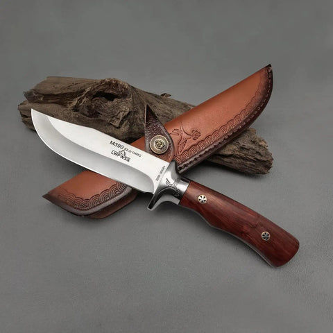 M390 Fixed Blade Hunting Knife With Wood Handle Full Tang Survival Knife Leather Sheath Built For Rugged Outdoor Camping Bushcraft and Beast Mode Wilderness Tasks No Cap displayed on wood background.