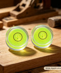 Two 4Pcs Small Circular Bubble Levels, Double Sided Adhesive Bottom Mini on wood, showing vibrant green liquid and level bubbles.