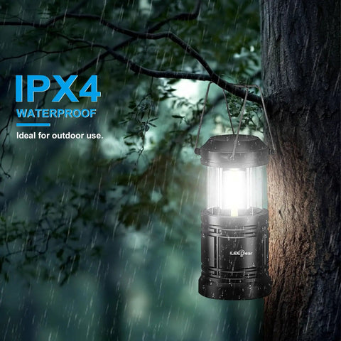 Portable LED Camping Lantern 2-Pack with Battery Operated Lights hanging on a tree in rain, 360-degree illumination, outdoor use