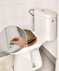Kick Up Your Bathroom Style With These Pretty Dang Cute Ceramic Frog Toilet Bolt Cover Set Featuring Sturdy Tank Caps And Whimsical Hardware Accessories with a hand holding a frog cover.