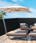 Black Privacy Screen Fence Mesh Cover 5ft By 50ft Heavy Duty Shade Net for Outdoor Walls and Yards with outdoor furniture on wooden deck.