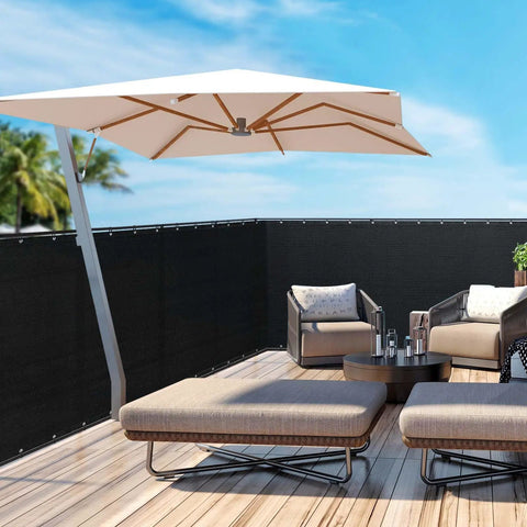 Black Privacy Screen Fence Mesh Cover 5ft By 50ft Heavy Duty Shade Net for Outdoor Walls and Yards with outdoor furniture on wooden deck.