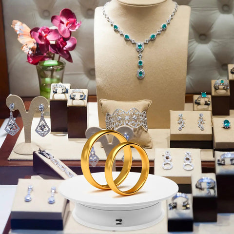 Must Have Electric Rotating Display Turntable With 360 Degree Spin, Auto Speed Control, And Suede Base showcasing golden rings and jewelry.