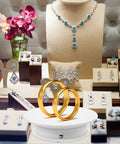 Gold wedding rings displayed on Awesome 360 Rotating Display Turntable Adjustable Electric Stand For Jewelry Photos.