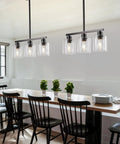Sleek Black Three Light Kitchen Island Pendant Lamps Using Dimmable E26 Base illuminating a dining table with a relaxed ambiance.