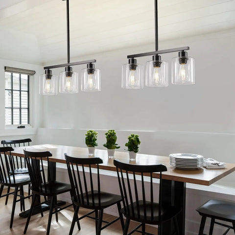 Sleek Black Three Light Kitchen Island Pendant Lamps Using Dimmable E26 Base illuminating a dining table with a relaxed ambiance.