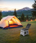 Road Ready Portable Camping Outdoor Toilet For Adults With Secure Snap Lid, Super Sturdy Foldable Travel Potty And Leak Proof Porta Potty For Rv Vans Grey in a scenic camping setting.