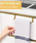 Gold stainless steel over the cabinet door towel rack with quilted towel, tool-free installation on kitchen cupboard.