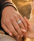 Mens Titanium Steel Ring Silver Plated With Grid Cubic Zirconia Inlay worn on a hand, shown as a couple holds hands.
