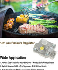 1/2 inch gas pressure regulator with yellow knob and silver body shown on a barbecue grill with steak, corn, and asparagus.