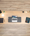 Top view of office desk setup with laptop, notebook, and Black 28 Inch Standing Desk Converter Sit To Stand Monitor Riser