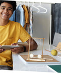 Teen holding tablet with Two Piece Physics Experiment Kit With Floating Ball Tools For School Learning Safe Materials on desk