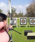 Person aiming at Backyard Archery Target For Adults EVA Foam 20x20x2 Inch Block For Bows Up To 50 Lbs Heavy Duty Practice Target