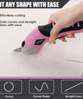 Hot 4V Cordless Electric Scissors With 3 Sharp Blades For Fabric And Cardboard cutting fabric effortlessly with a pink handheld shear.