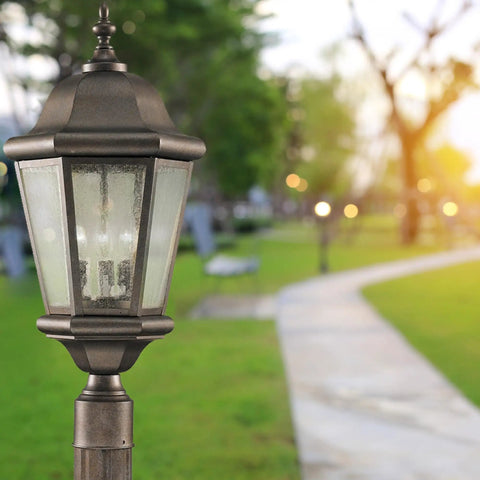 Martinsville Outdoor Post Lantern 3 Light Bronze Stainless Steel Construction Dope Post Light, 22 inch high mounted in garden setting.