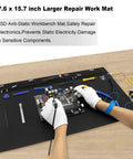 Person using Extra Large Anti Static Soldering Mat with grounding accessories and wrist strap, 27.6 x 15.7 inch, black.