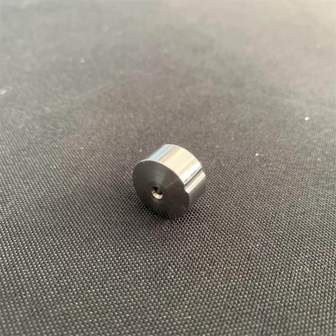 Angled front view of a small stainless steel waterjet check valve seat with central bore