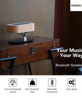 Tree Of Aura Smart Bedside Lamp With Wireless Charging, Bluetooth Speaker on wooden table, showcasing sleek design.