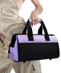 Person holding Purple Tool Bag With Wide Mouth Opening And 12 Storage Pockets, 13 Inch Tool Organizer, Water Resistant Durable Construction.