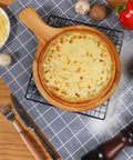 Upgrade Your Holiday Cooking Game With This No Sweat Manual Pizza Dough Press Machine Heavy Duty Construction Perfect For Rolling Tortillas Sheet Fresh Pasta And Crushing Out Flawless Pie Crusts At Home: pizza cooked in a wooden round dish, surrounded by fresh ingredients.