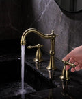 Hand using 8 Inch Widespread Brushed Gold Bathroom Faucet With Overflow Pop Up Drain Assembly And 3 Hole Mount Solid Brass Vanity Sink Tap Complete With cUPC Water Supply Lines For Dope Luxury Look