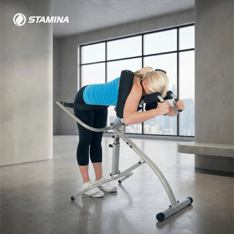 Woman using InLine Traction Control System For Back Pain Relief And Spine Decompression in a home gym setting.