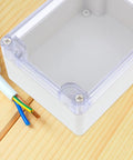 Close-up of Rugged Weatherproof Plastic Electrical Project Enclosure Box With Secure Cover, showing clear lid and wires.